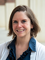 Woman with short brown hair smiling at camera