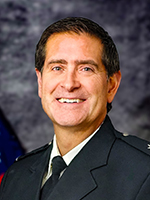 Man with dark hair smiling at camera