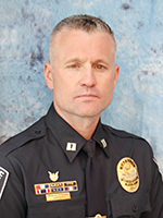 Man with short hair and police uniform