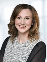 Woman with short brown hair smiling at camera