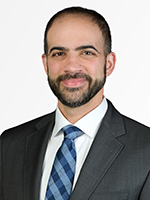 Man in suit and tie smiling at camera